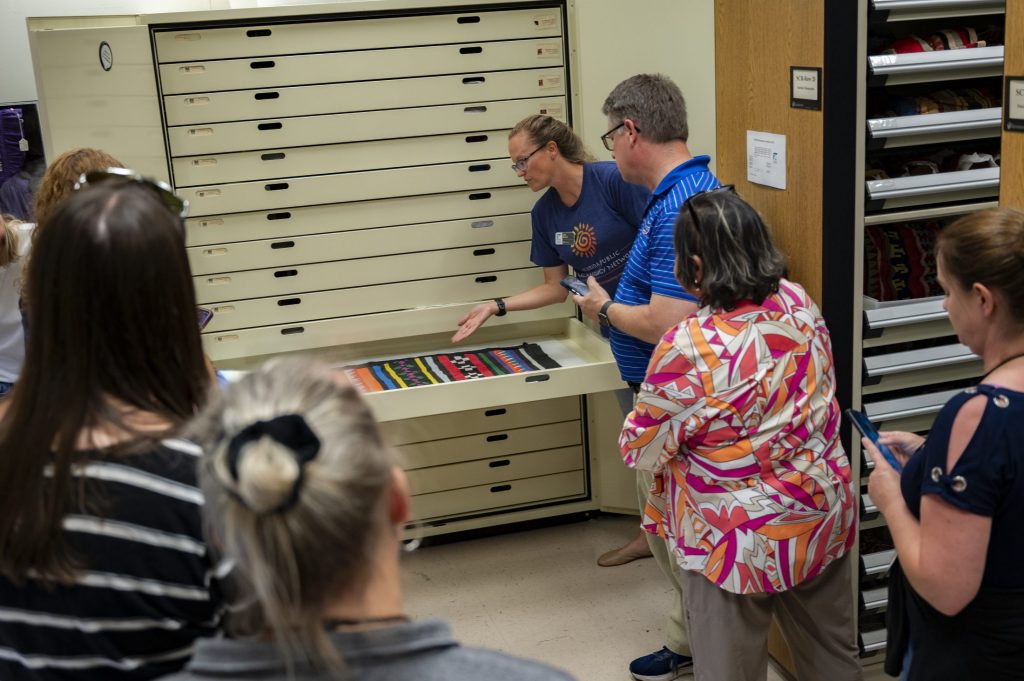 Archaeology collections manager Jen Green shows the teachers the archaeology collections.