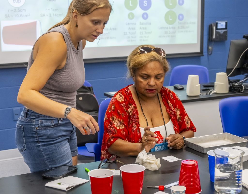 Elizabeth Searl works with UF graduate student Kara Taylor.