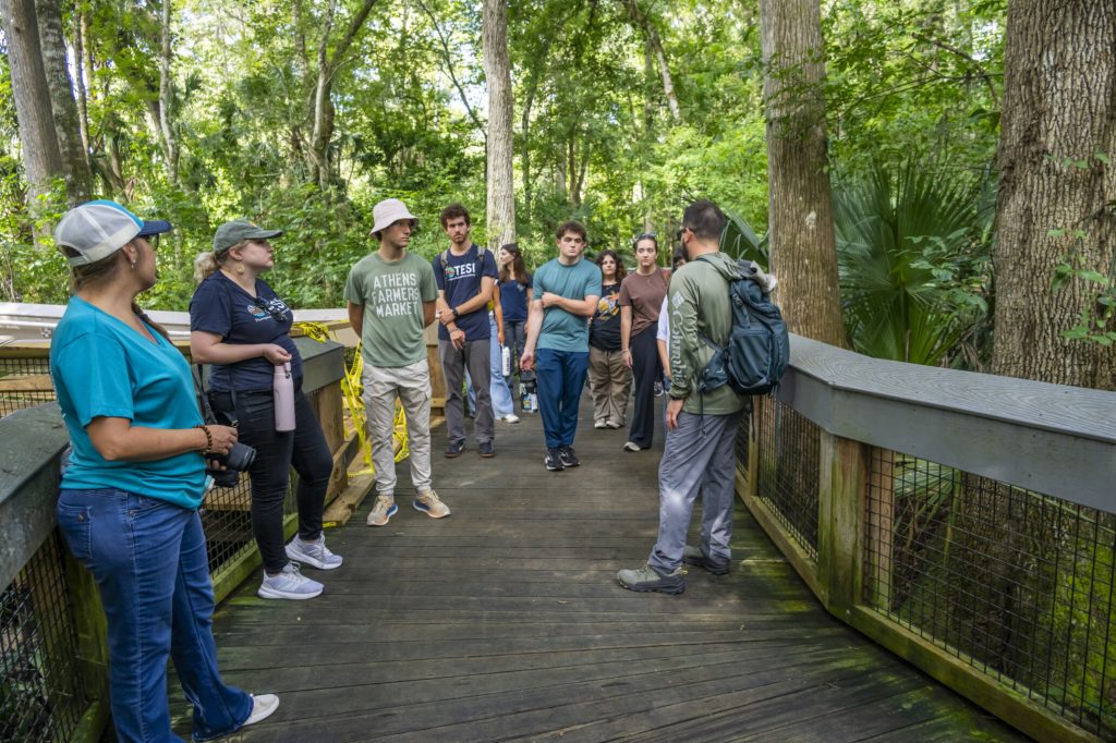 Matthew Stanley leading fellows on a walk on the Silver Springs boardwalk.