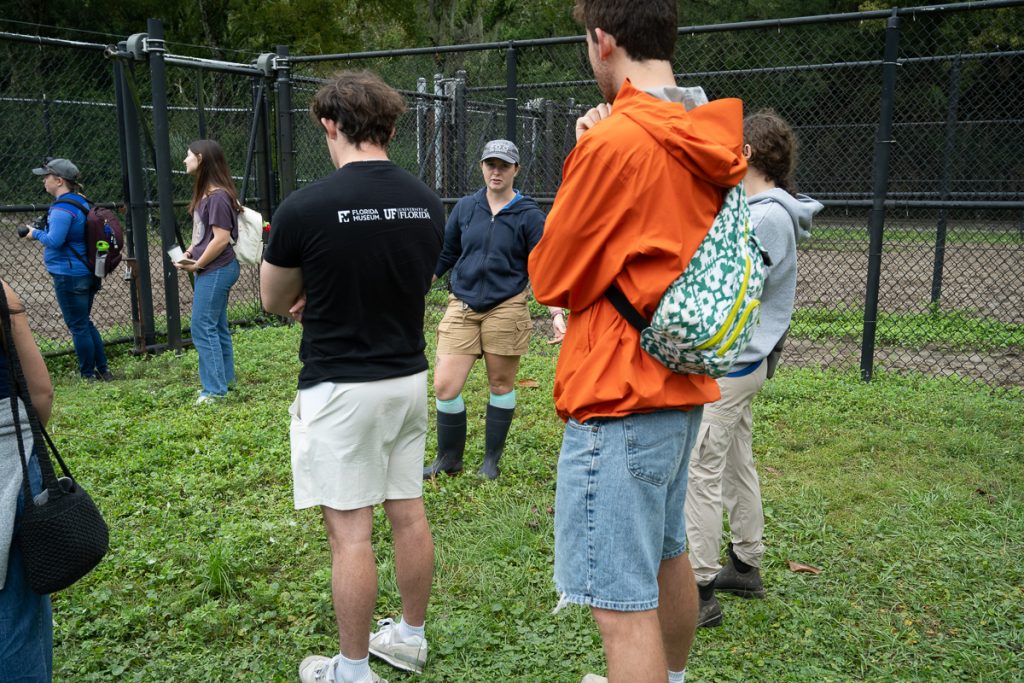 A Jacksonville Zoo zookeeper talks to the fellows standing in a circle about their career paths.