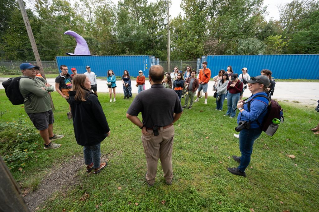 Fellows and Dr. Hallett's students stand outside the zoo classrooms discussing careers in zoo education.