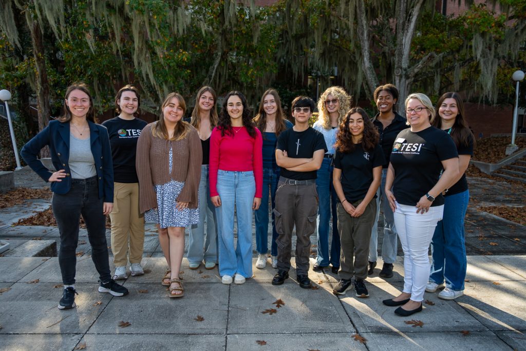 Spring 2026 ELF cohort standing outside of Dickinson Hall in a row, all smiling. Left to right: Hannah, Lexi Bolger, Sol, Madison, Zoey, Maggie, Eva, Ren, Melina, Azhalia, Megan Ennes, Elle Henson