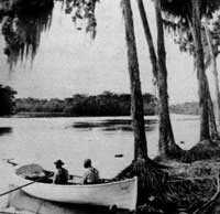 two men sitting in a rowboat on the St. Johns River