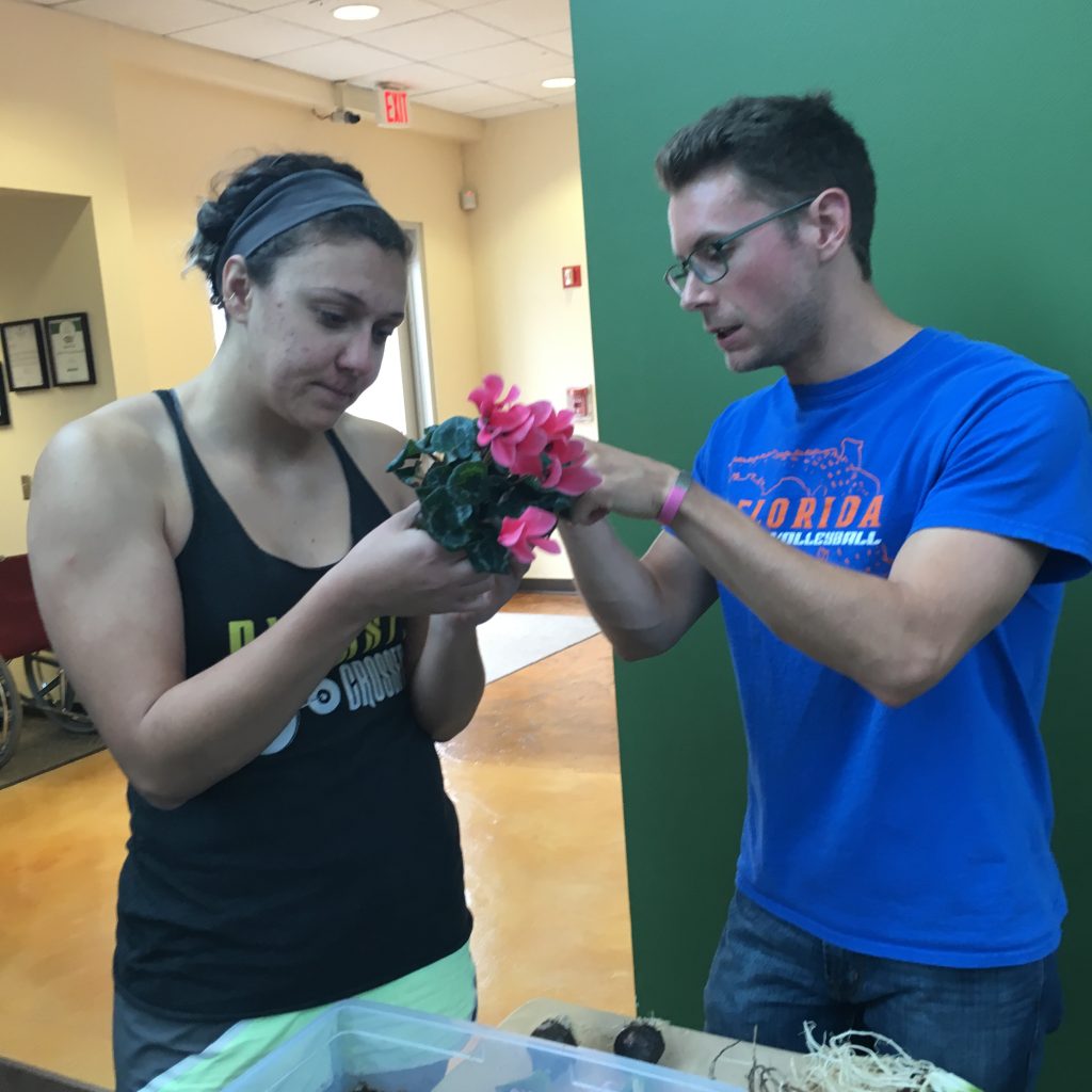 students holding flowers