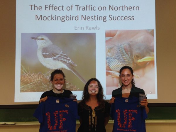 award winning undergraduate researchers posing with their prizes and their graduate student mentor