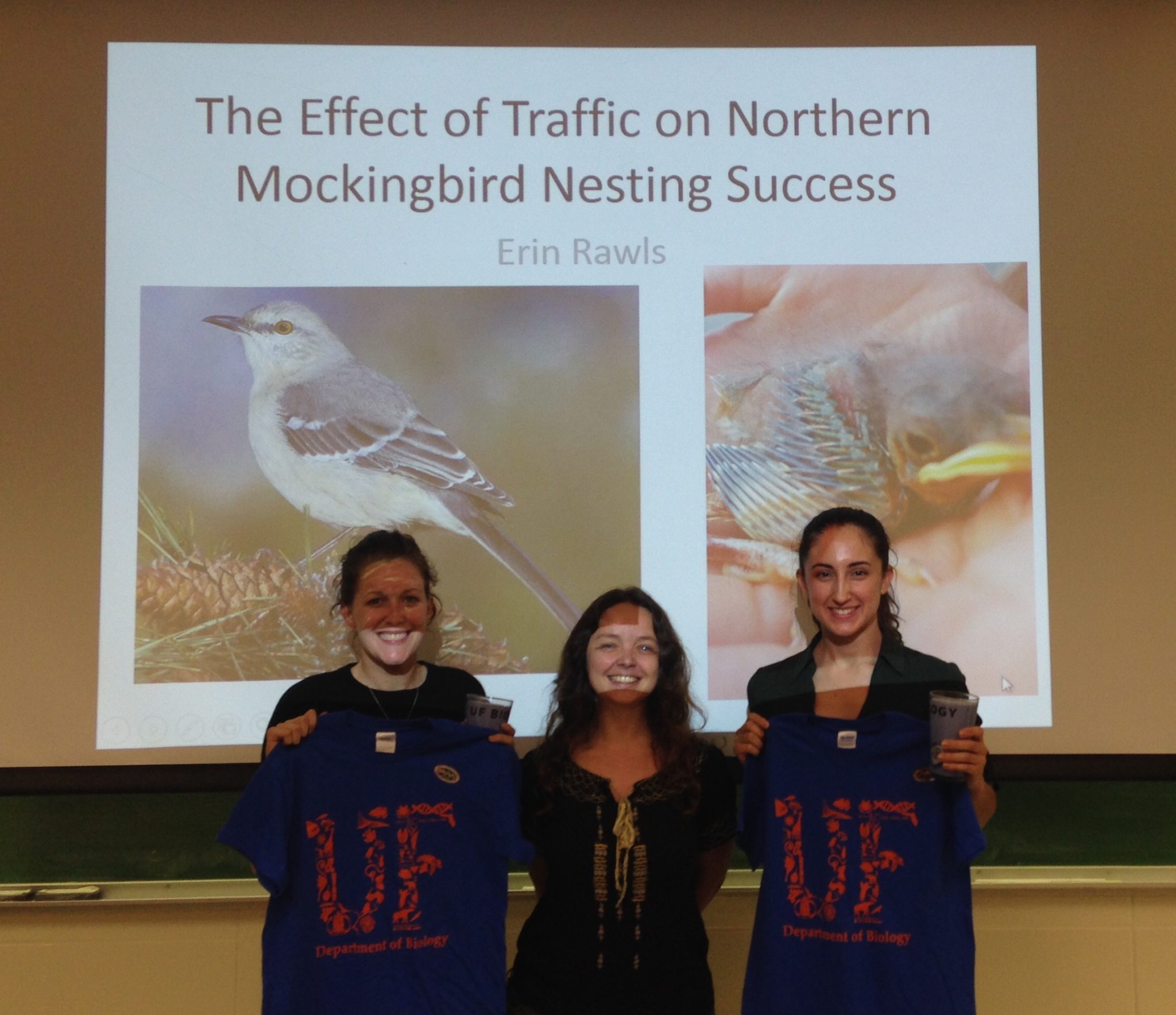 award winning undergraduate researchers posing with their prizes and their graduate student mentor