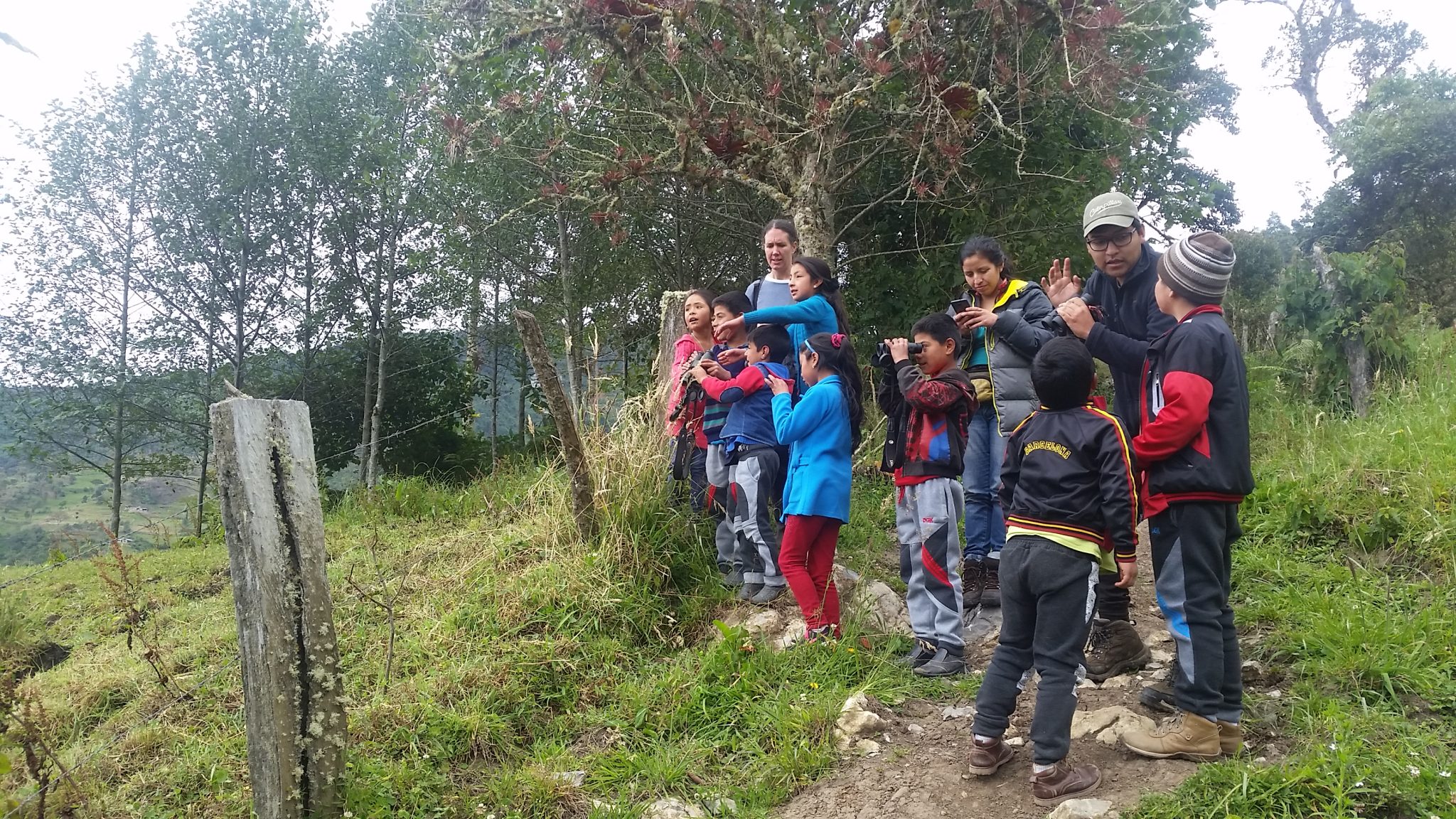 children learning how to use binoculars
